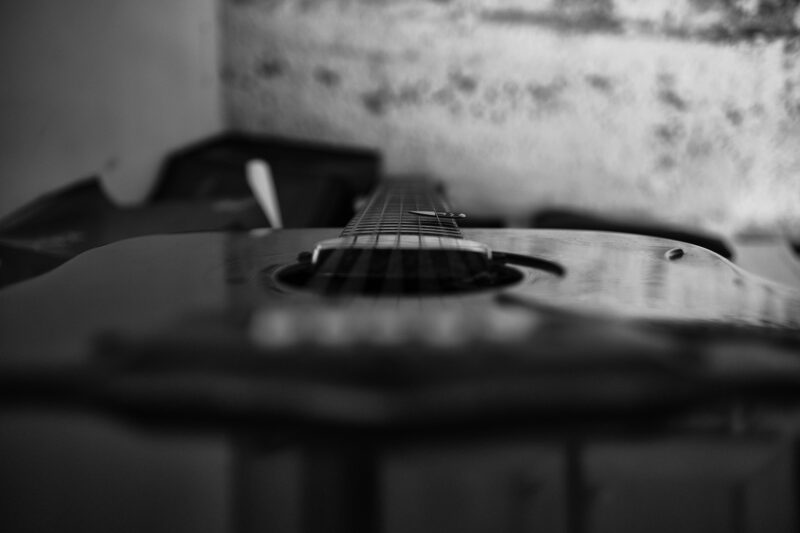Music Career: Black and white close up of guitar head