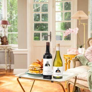 Woman Dinner: Living room with two bottles of wine and a burger on a TV tray