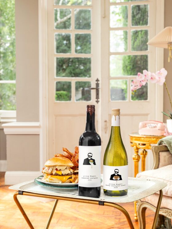 Woman Dinner: Living room with two bottles of wine and a burger on a TV tray