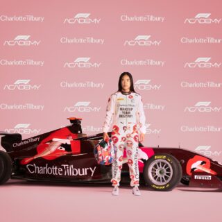 F1 Academy: Charlotte Tilbury emblazoned F1 racing car with Chloe Chong standing in front of it and a step and repeat