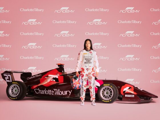 F1 Academy: Charlotte Tilbury emblazoned F1 racing car with Chloe Chong standing in front of it and a step and repeat