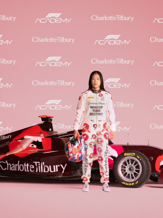 F1 Academy: Charlotte Tilbury emblazoned F1 racing car with Chloe Chong standing in front of it and a step and repeat