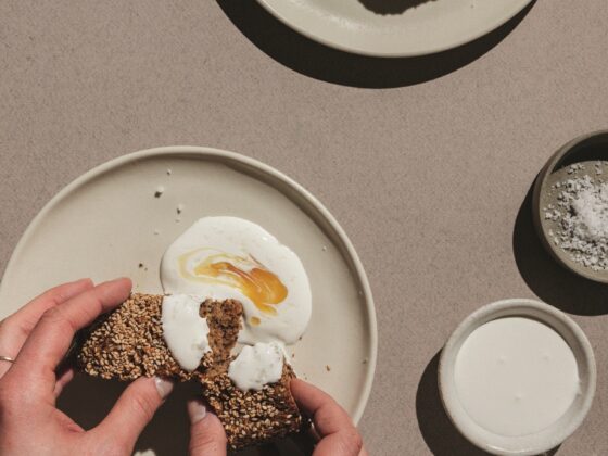 Banana Bread: Woman's hands spreading creme fraiche on bread