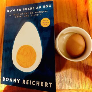 How to Share an Egg: Copy of the book next to a small dish with a hard-boiled egg