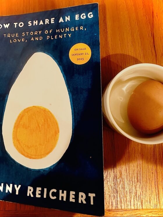How to Share an Egg: Copy of the book next to a small dish with a hard-boiled egg