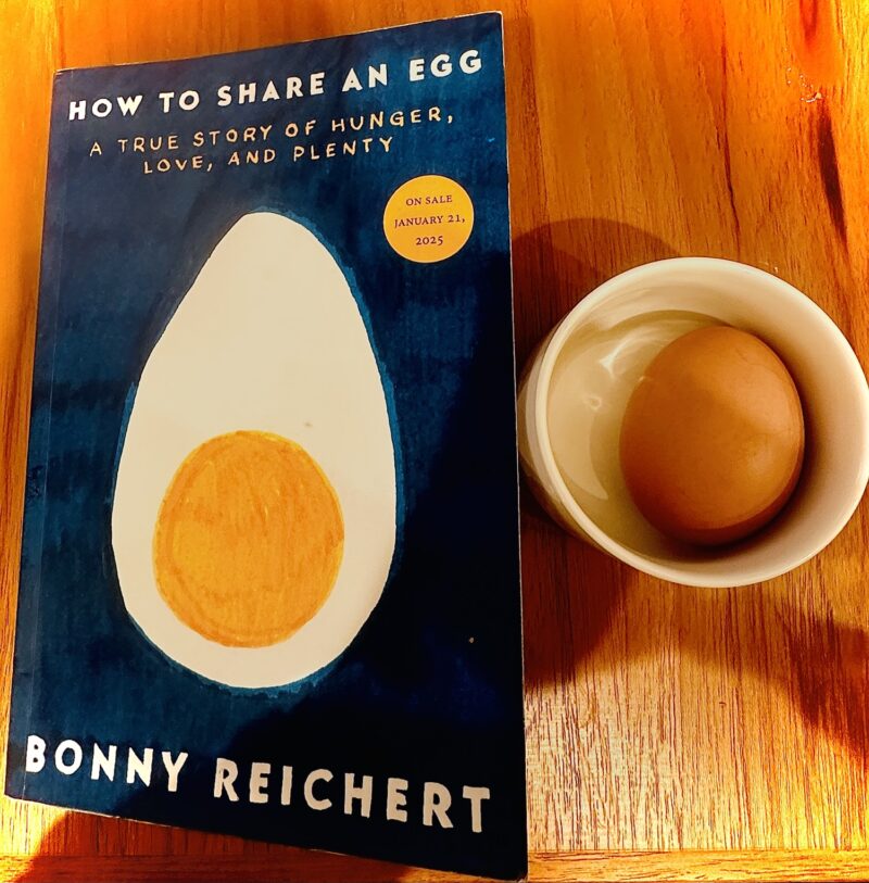 How to Share an Egg: Copy of the book next to a small dish with a hard-boiled egg