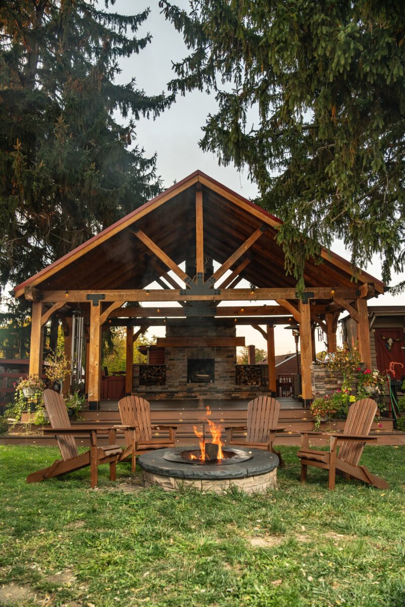 Wood Staining: Wooden patio with Muskoka Chairs around a fire pit