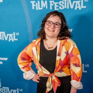 The Latest With Maya: Maya Abrahamsson in front of a step and repeat