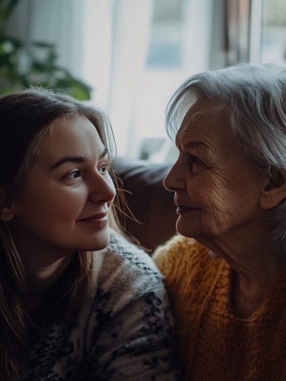 Shiftcare: Young woman sitting next to a much older woman