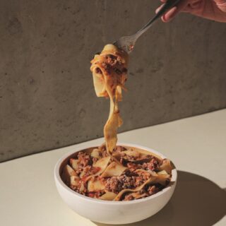 Bolognese: Pasta in a bowl with Bolognese being twirled on a fork