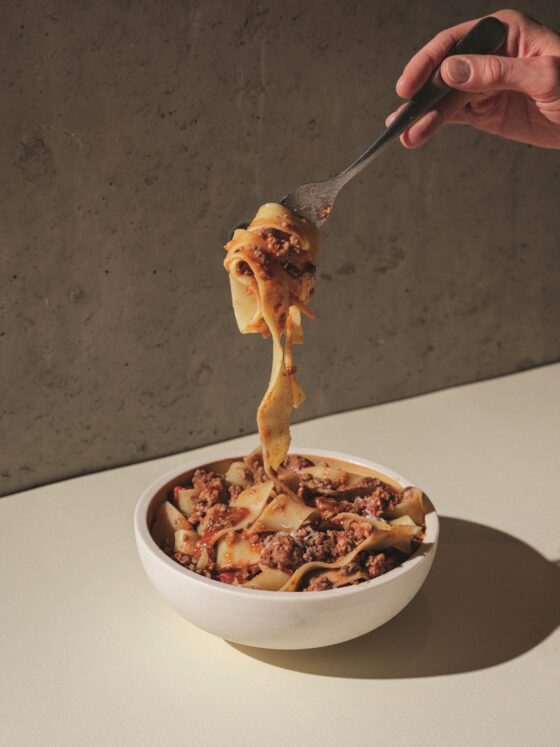 Bolognese: Pasta in a bowl with Bolognese being twirled on a fork