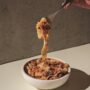 Bolognese: Pasta in a bowl with Bolognese being twirled on a fork