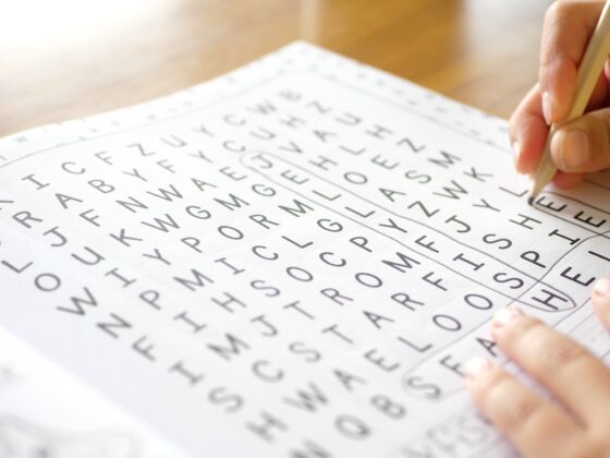 Wordsearch: Close up of a hand working on a wordsearch