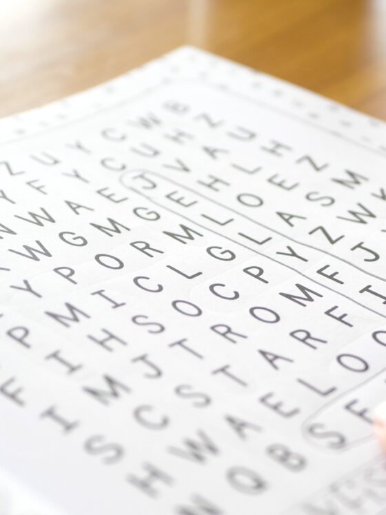 Wordsearch: Close up of a hand working on a wordsearch