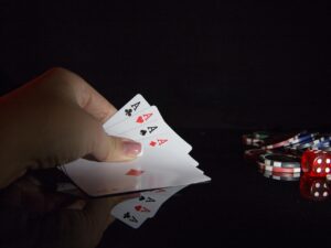 The Casino: Woman's hand with 4 aces and poker chips nearby