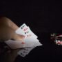 The Casino: Woman's hand with 4 aces and poker chips nearby