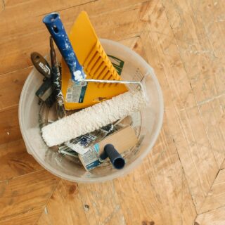 Restoration experts: tools in a bucket on a wooden floor