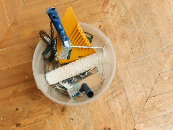 Restoration experts: tools in a bucket on a wooden floor