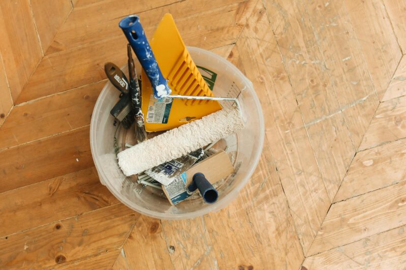 Restoration experts: tools in a bucket on a wooden floor