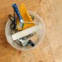 Restoration experts: tools in a bucket on a wooden floor