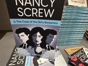 Nancy Screw & The Case of the Dirty Benjamins: Stack of books