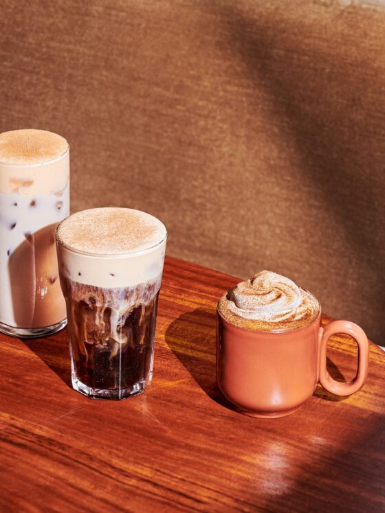 New Menu: Starbucks Pumpkin Spice Latte, Pecan Cortado, Pumpkin Spice Cold Brew and Pumpkin Spice Chai Latte in glasses on a wooden table
