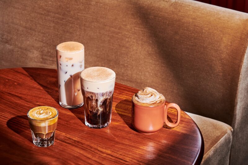 New Menu: Starbucks Pumpkin Spice Latte, Pecan Cortado, Pumpkin Spice Cold Brew and Pumpkin Spice Chai Latte in glasses on a wooden table