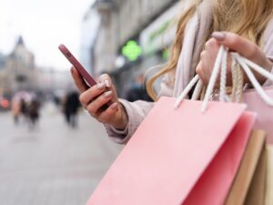 Refresh your look: young adult with shopping bags in the city