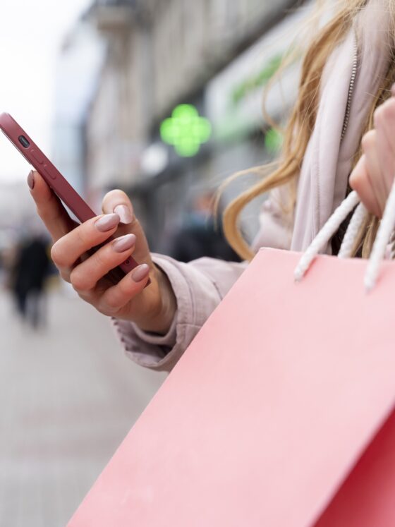 Refresh your look: young adult with shopping bags in the city