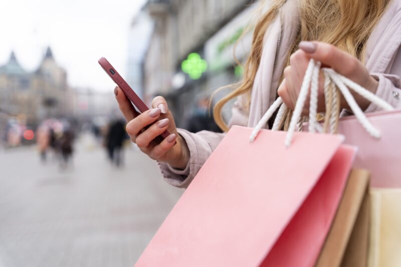 Refresh your look: young adult with shopping bags in the city