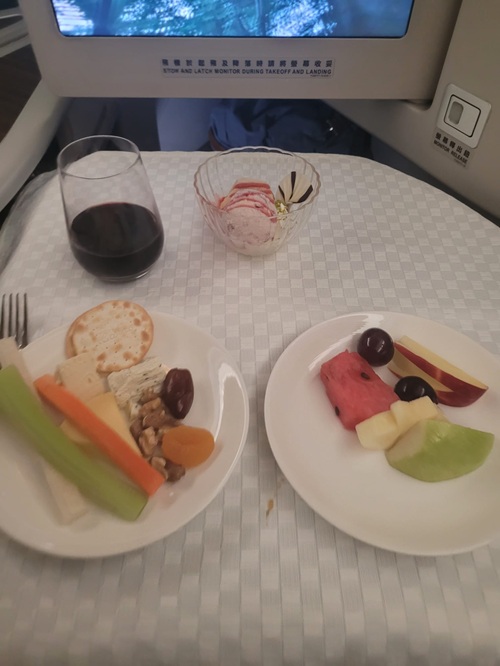 EVA Air Royal Laurel Class: Cheese Plate with Red Wine and fruit on an airplane tray
