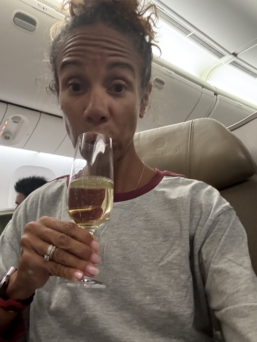 EVA Air Royal Laurel Class: Natalie Preddie sipping white wine in her airplane seat