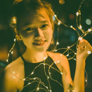 Girls' Night In: Vietnamese Young Woman surrounded by fairy lights
