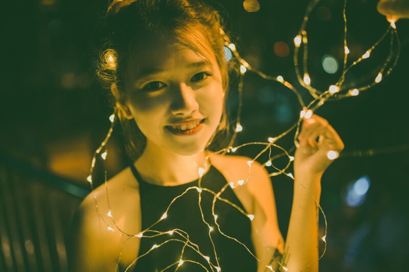 Girls' Night In: Vietnamese Young Woman surrounded by fairy lights