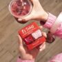 Nails.INC’s It’s Topless: Woman's hand holding two nail polishes and a drink with a straw