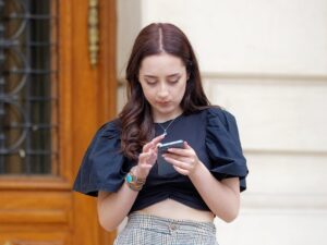 Online Casino Reviews: Woman on her mobile phone outside