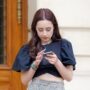Online Casino Reviews: Woman on her mobile phone outside