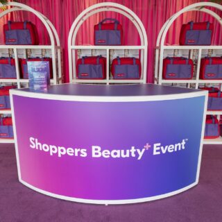 Shoppers Beauty: Check in Desk + red and purple bags