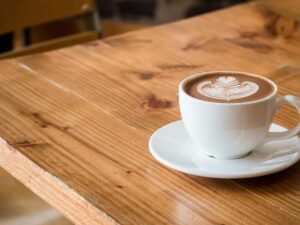 Coffee Breaks: Latte in a cup with saucer on a table