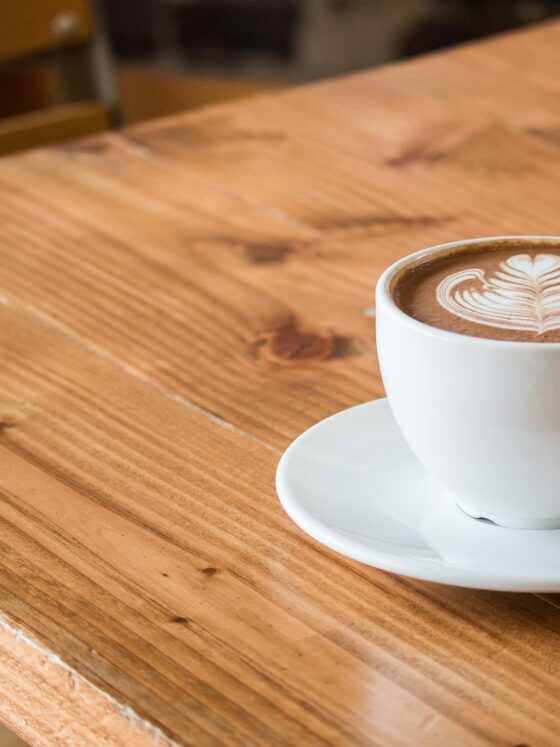 Coffee Breaks: Latte in a cup with saucer on a table