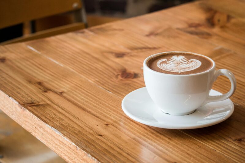 Coffee Breaks: Latte in a cup with saucer on a table