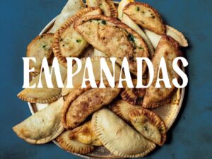 Empanadas: Cookbook cover with a pile of empanadas featured