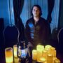 Beverley Street Séance RESURRECTION: Jaymes White in front of electric candles and lanterns