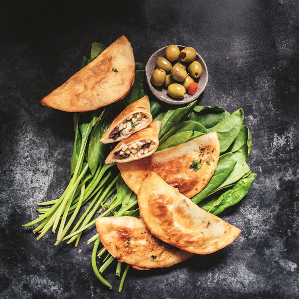 Empanadas: Spinach and Feta Empanadas with a bowl of olives near