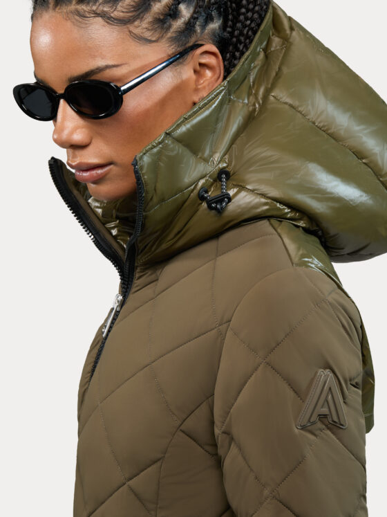 Alpenhaus: Woman in a khaki parka wearing sunglasses