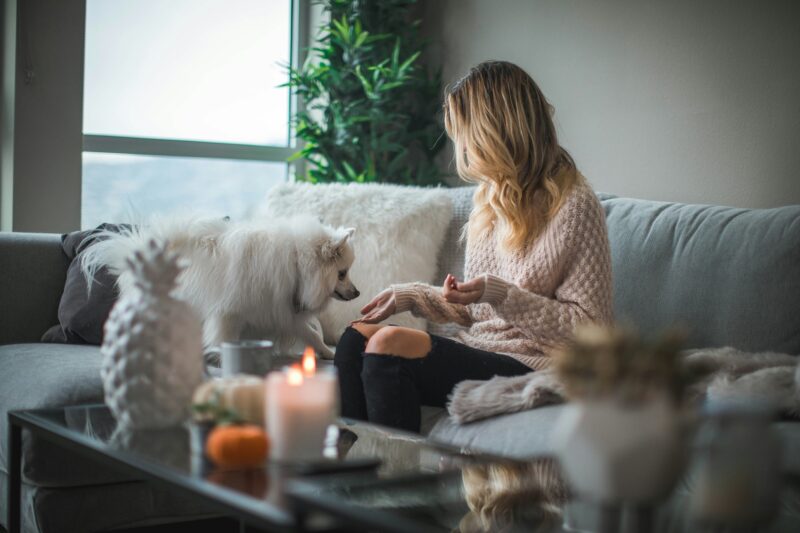 At-Home Leisure: Woman on a couch with a dog