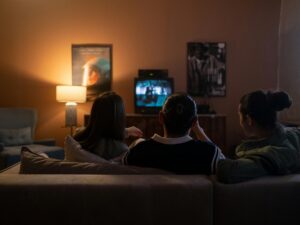 Best Canadian Entertainment Platforms: Friends Sitting Together on a Couch in front of a TV