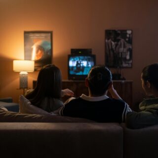 Best Canadian Entertainment Platforms: Friends Sitting Together on a Couch in front of a TV