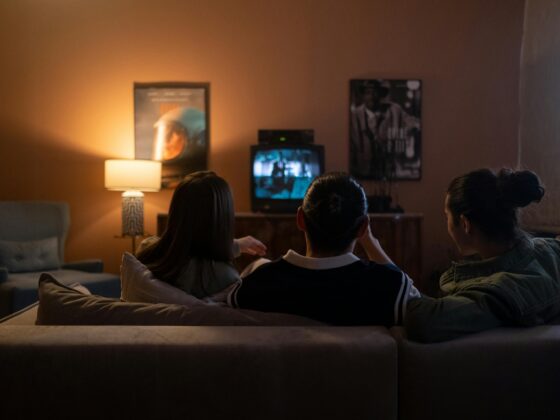 Best Canadian Entertainment Platforms: Friends Sitting Together on a Couch in front of a TV
