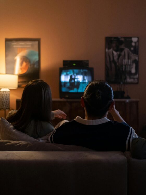 Best Canadian Entertainment Platforms: Friends Sitting Together on a Couch in front of a TV